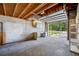 View of open garage with workbench, overhead storage, and access to outside area at 6219 Hampton N Dr, St Petersburg, FL 33710