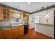 Charming kitchen with tile floors, wood cabinets, and pass-through to the dining area at 6219 Hampton N Dr, St Petersburg, FL 33710