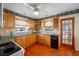 Kitchen with classic wood cabinets, green counters, and modern appliances at 6219 Hampton N Dr, St Petersburg, FL 33710