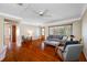 Inviting living room with hardwood floors, large windows, and cozy seating arrangement at 6219 Hampton N Dr, St Petersburg, FL 33710