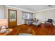 Cozy living room featuring hardwood floors, a decorative front door, and comfortable seating at 6219 Hampton N Dr, St Petersburg, FL 33710