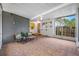 This cozy screened patio has tile flooring, a seating area, and access to the backyard, perfect for relaxation and entertainment at 6219 Hampton N Dr, St Petersburg, FL 33710