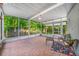 Cozy screened-in patio with tile floors, seating, and natural light, ideal for enjoying the outdoors in comfort at 6219 Hampton N Dr, St Petersburg, FL 33710