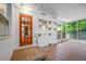 View of screened in porch, with tiled floor and glass paned door at 6219 Hampton N Dr, St Petersburg, FL 33710