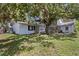 The back of the home features a cozy deck, great yard space and mature trees for added privacy at 6301 13Th N Ave, St Petersburg, FL 33710