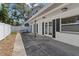 Large backyard patio with double french doors, black accent shutters and a privacy fence for outdoor living at 6301 13Th N Ave, St Petersburg, FL 33710