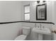 Classic bathroom featuring a pedestal sink, toilet, and black and white tile ready for remodel at 6301 13Th N Ave, St Petersburg, FL 33710