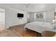 Minimalist bedroom with a queen bed, wood floors, and a mounted television at 6301 13Th N Ave, St Petersburg, FL 33710