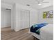 Bedroom featuring closet, wood-look flooring, and a large window at 6301 13Th N Ave, St Petersburg, FL 33710