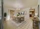Bright dining room with stylish chandelier, table set for six, and view of kitchen at 6301 13Th N Ave, St Petersburg, FL 33710