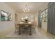 Dining room with a large table set for eight, neutral colors, and natural light at 6301 13Th N Ave, St Petersburg, FL 33710
