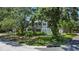 Charming two-story home nestled on a corner lot, surrounded by mature trees for added privacy at 6301 13Th N Ave, St Petersburg, FL 33710