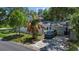 This home features an attached garage, a driveway, and a well-maintained yard enclosed by a white fence at 6301 13Th N Ave, St Petersburg, FL 33710