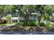 Inviting two-story home with a classic design, complemented by lush greenery and mature trees at 6301 13Th N Ave, St Petersburg, FL 33710