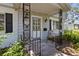 A quaint front porch features decorative iron railings and a comfortable seating area with a charming rocking chair at 6301 13Th N Ave, St Petersburg, FL 33710