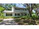 Charming two-story home with a combination of white brick and wood siding, and mature landscaping at 6301 13Th N Ave, St Petersburg, FL 33710
