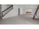 Spacious open floor plan with exposed concrete flooring, staircase access, and ample natural light at 6301 13Th N Ave, St Petersburg, FL 33710