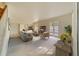 Bright living room featuring stylish gray furniture, a warm wood media console, and direct access to the backyard at 6301 13Th N Ave, St Petersburg, FL 33710