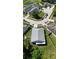 An aerial view showcases a house nestled in a neighborhood with mature trees, neat yards, and community streets at 6318 Ashfield Pl, Wesley Chapel, FL 33545