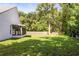 Spacious backyard featuring lush green grass and a fenced perimeter for privacy at 6318 Ashfield Pl, Wesley Chapel, FL 33545