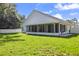 Expansive backyard featuring a screened-in porch and a white privacy fence at 6318 Ashfield Pl, Wesley Chapel, FL 33545