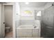 Clean bathroom featuring a soaking tub and a glass shower stall at 6318 Ashfield Pl, Wesley Chapel, FL 33545
