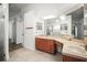 Bathroom featuring double sinks, generous vanity counter space and tile floors at 6318 Ashfield Pl, Wesley Chapel, FL 33545