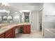 Bathroom featuring double sinks, generous vanity counter space and tile floors at 6318 Ashfield Pl, Wesley Chapel, FL 33545
