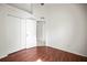 Bright bedroom with wood floors, closet, and ceiling fan at 6318 Ashfield Pl, Wesley Chapel, FL 33545
