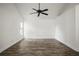 Bright bedroom with wood-look flooring, a ceiling fan, and ample natural light at 6318 Ashfield Pl, Wesley Chapel, FL 33545