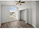 Bedroom featuring natural light, ceiling fan, and closet with wood floors at 6318 Ashfield Pl, Wesley Chapel, FL 33545