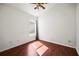Cozy bedroom with wood-look floors, ceiling fan, and a window for natural light at 6318 Ashfield Pl, Wesley Chapel, FL 33545