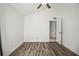Bedroom featuring wood floors, ceiling fan, neutral walls, and an open doorway to the hallway at 6318 Ashfield Pl, Wesley Chapel, FL 33545