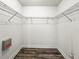 Walk-in closet with wood floors and wire shelving for optimal storage at 6318 Ashfield Pl, Wesley Chapel, FL 33545