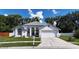 Charming single-story home with a well-manicured lawn, a two-car garage, and lovely curb appeal at 6318 Ashfield Pl, Wesley Chapel, FL 33545