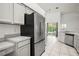 Bright kitchen featuring stainless steel refrigerator and view to the backyard at 6318 Ashfield Pl, Wesley Chapel, FL 33545