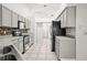 Functional kitchen with stainless steel appliances, white cabinets, and mosaic backsplash at 6318 Ashfield Pl, Wesley Chapel, FL 33545