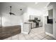 Open-concept kitchen, featuring stainless steel appliances, modern cabinetry, that flows into the adjacent living area at 6318 Ashfield Pl, Wesley Chapel, FL 33545