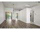 Bright and spacious living room with hardwood floors and sliding glass doors to the outside at 6318 Ashfield Pl, Wesley Chapel, FL 33545