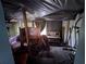 Unkempt bedroom featuring an old headboard with a black tarp overhead and personal items scattered throughout at 6515 30Th N St, St Petersburg, FL 33702