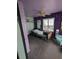 Bedroom with purple walls, a ceiling fan, and a hospital bed at 6515 30Th N St, St Petersburg, FL 33702