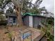 Exterior view of shed attached to a deck and the main house with large trees nearby at 6515 30Th N St, St Petersburg, FL 33702