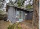 Exterior view of shed and side entrance, with an overgrown landscape and needing repairs, on the property at 6515 30Th N St, St Petersburg, FL 33702