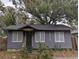 Quaint single-story home featuring a covered entrance, updated roof, and freshly painted gray siding at 6515 30Th N St, St Petersburg, FL 33702