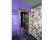 Hallway showcasing an antique cabinet, floral wallpaper, and purple walls at 6515 30Th N St, St Petersburg, FL 33702
