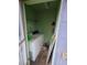 Small laundry room with outdated appliances, peeling paint, and an unfinished appearance; needs remodeling at 6515 30Th N St, St Petersburg, FL 33702