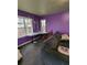 Den featuring purple walls, two large windows, a sofa, and a modern lamp at 6515 30Th N St, St Petersburg, FL 33702