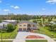 Stunning aerial view of a two-story home with a pool, golf course, and lush landscaping at 6780 Greenbrier Dr, Seminole, FL 33777