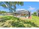 Spacious green backyard featuring an enclosed pool and lawn at 6780 Greenbrier Dr, Seminole, FL 33777