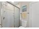 Bright bathroom with a sliding glass door shower and neutral tile at 6780 Greenbrier Dr, Seminole, FL 33777